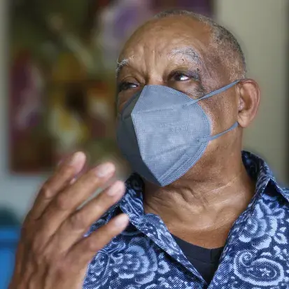 Man wearing a face mask talking