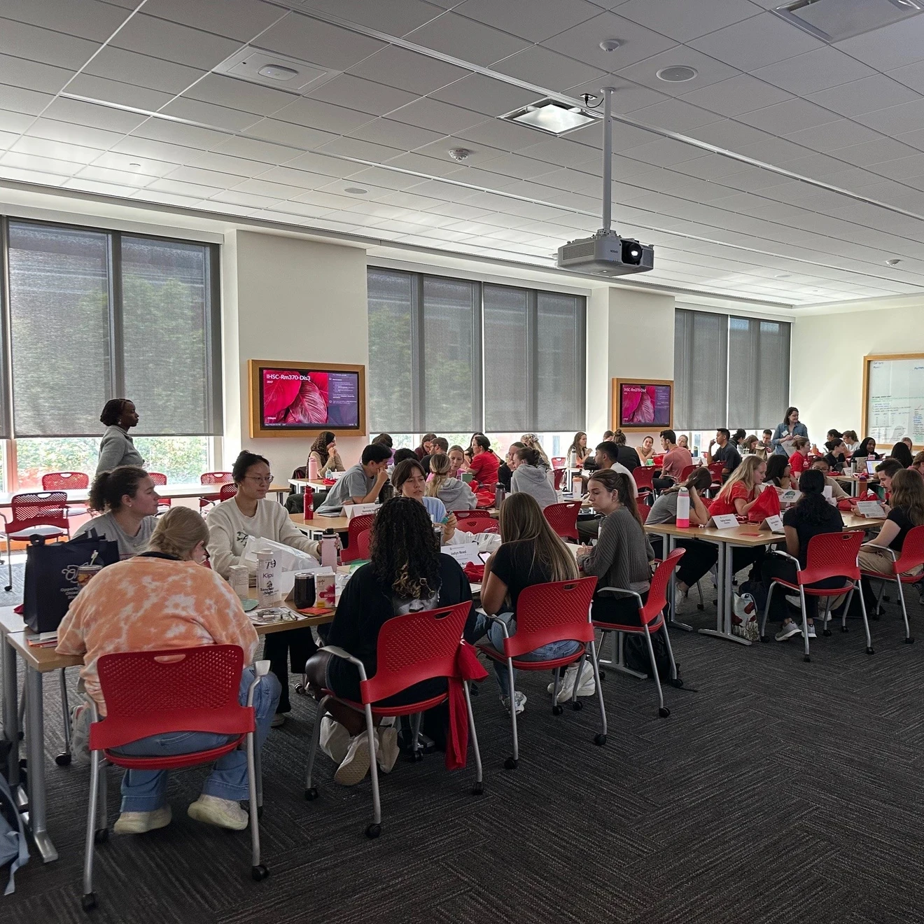 A group of interprofessional students learning in a classroom