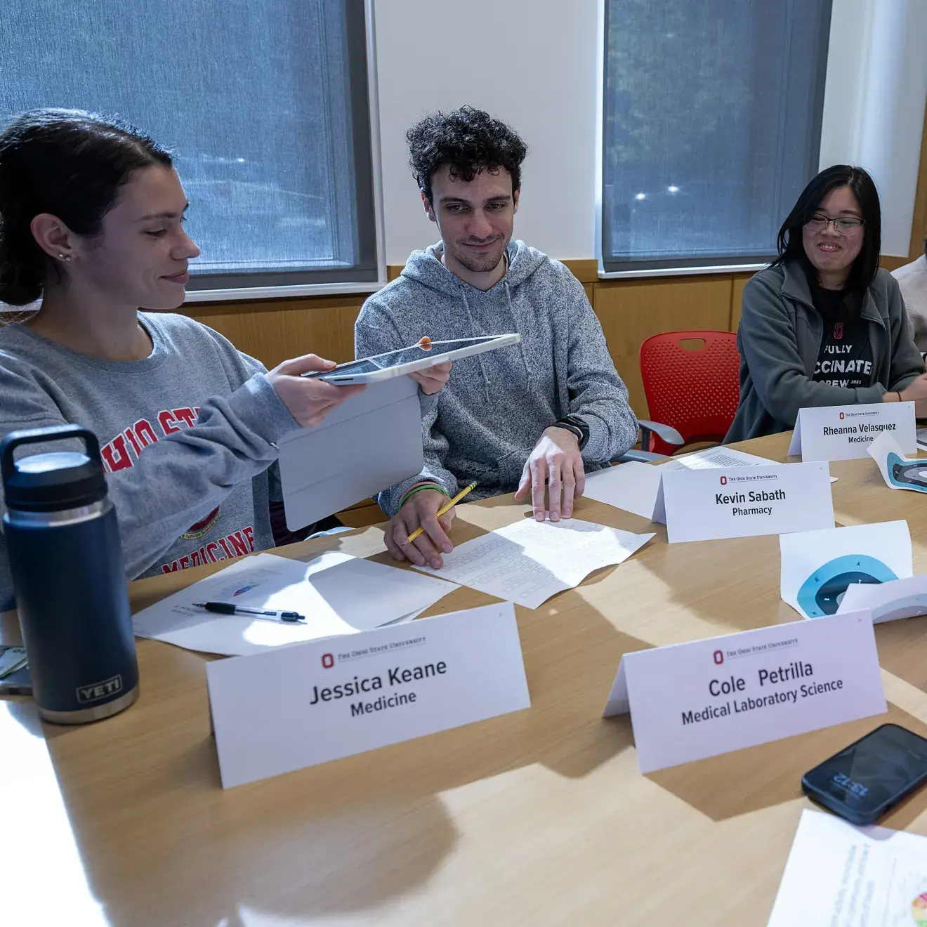 Students learning from each other at a table
