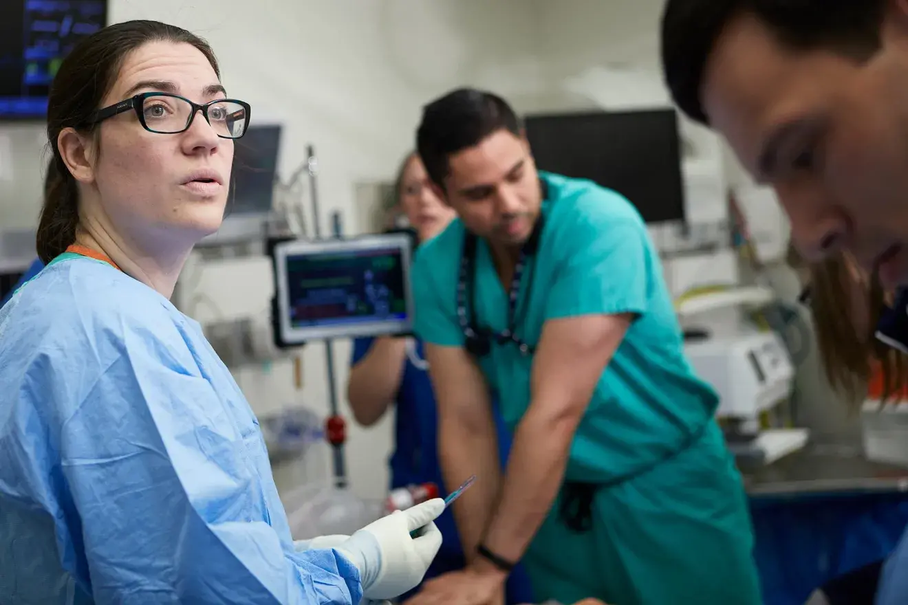 Three clinicians working together on a patient 