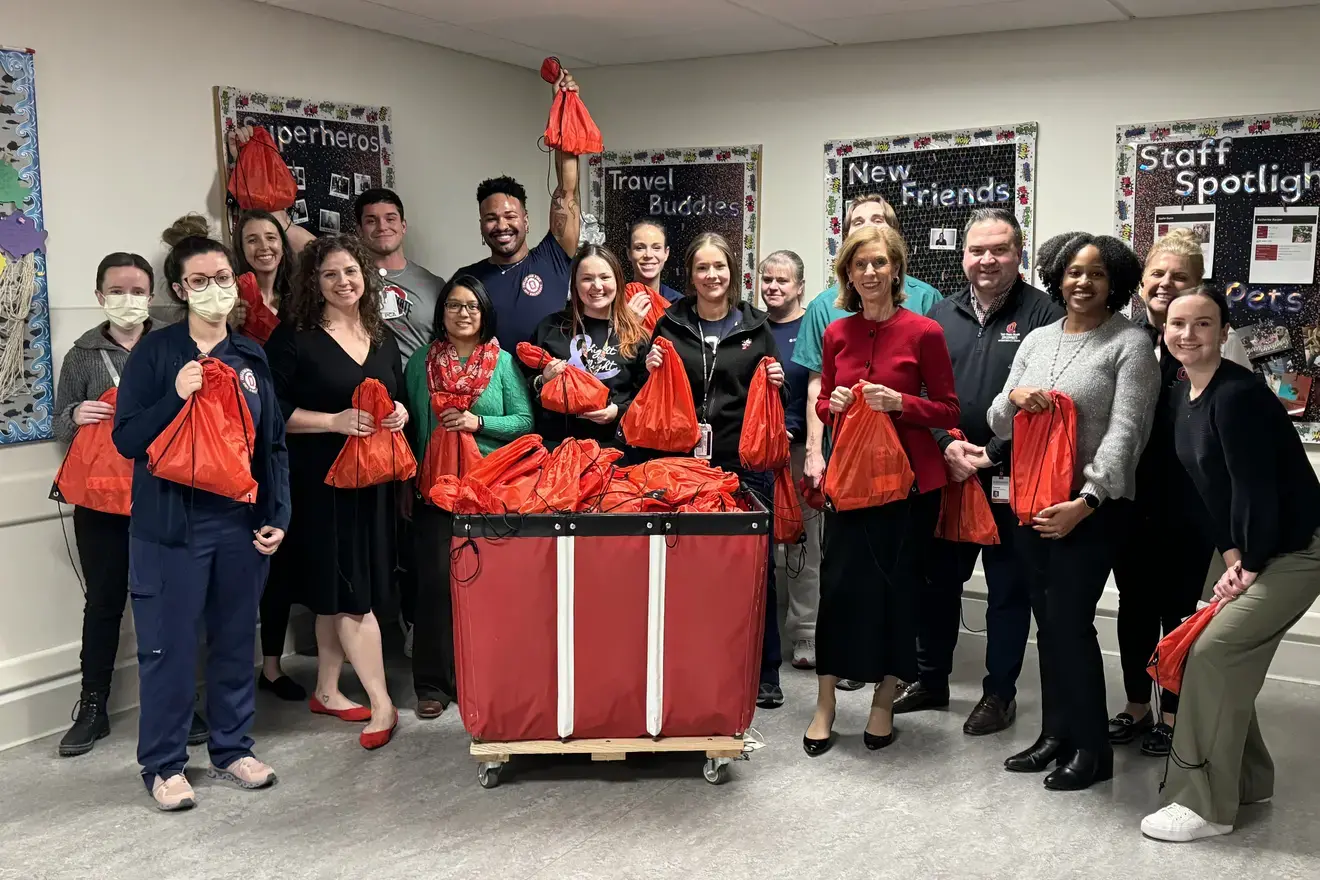 Office of IPE and ER staff posing with donated bags