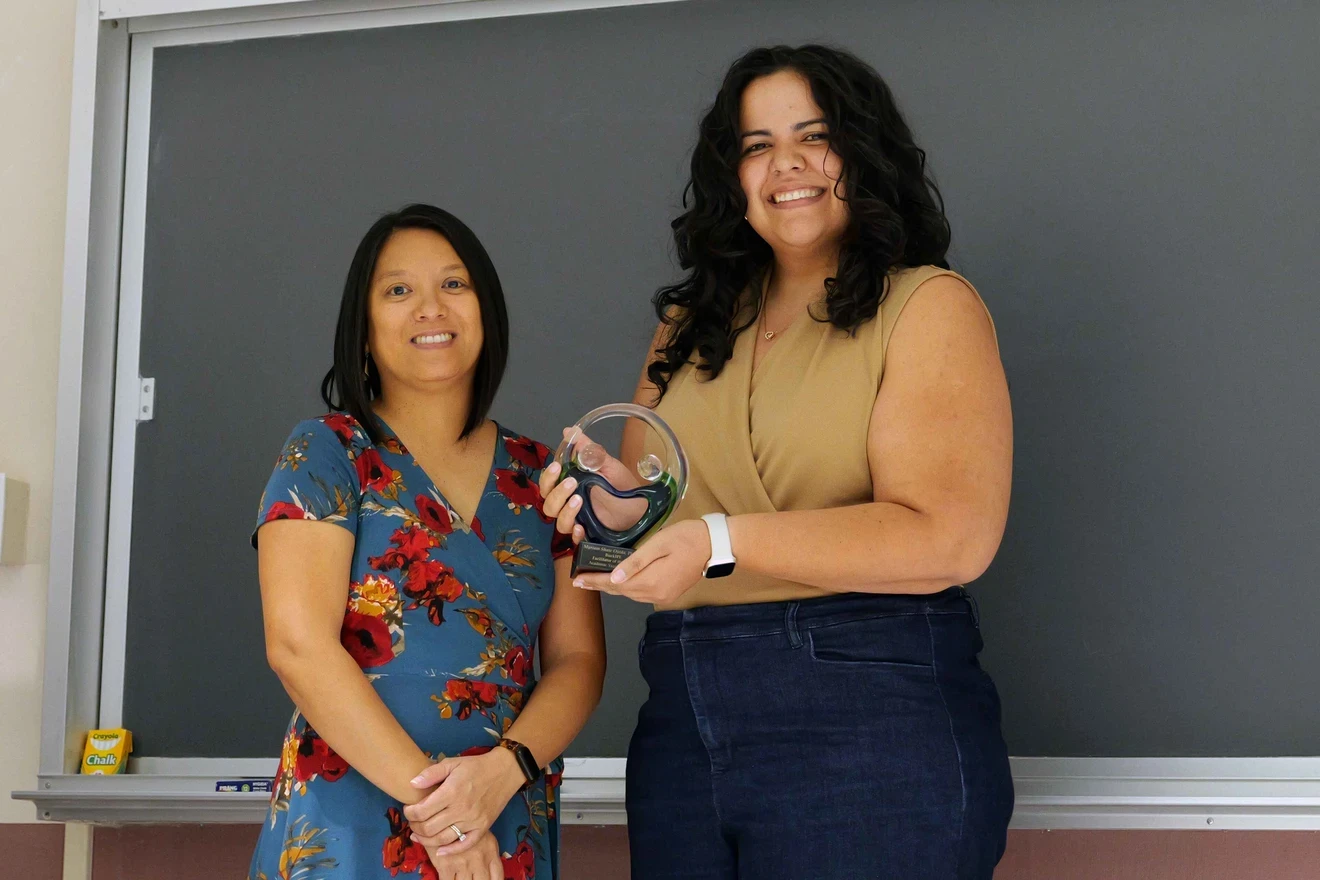 Facilitator of the Year Myriam Shaw Ojeda posing with her award and Office of IPE Dr. Cynthia Dougherty