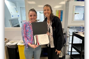 Trainee Facilitator of the Year Taylor Frace posing with her award and Office of IPE Liz Trolli