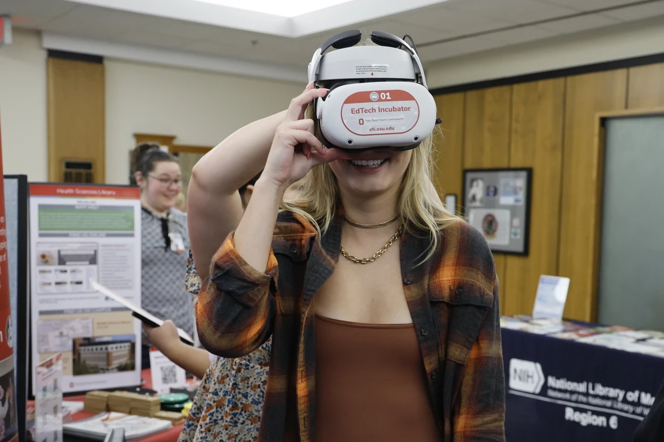 A student smiling and wearing a VR headset